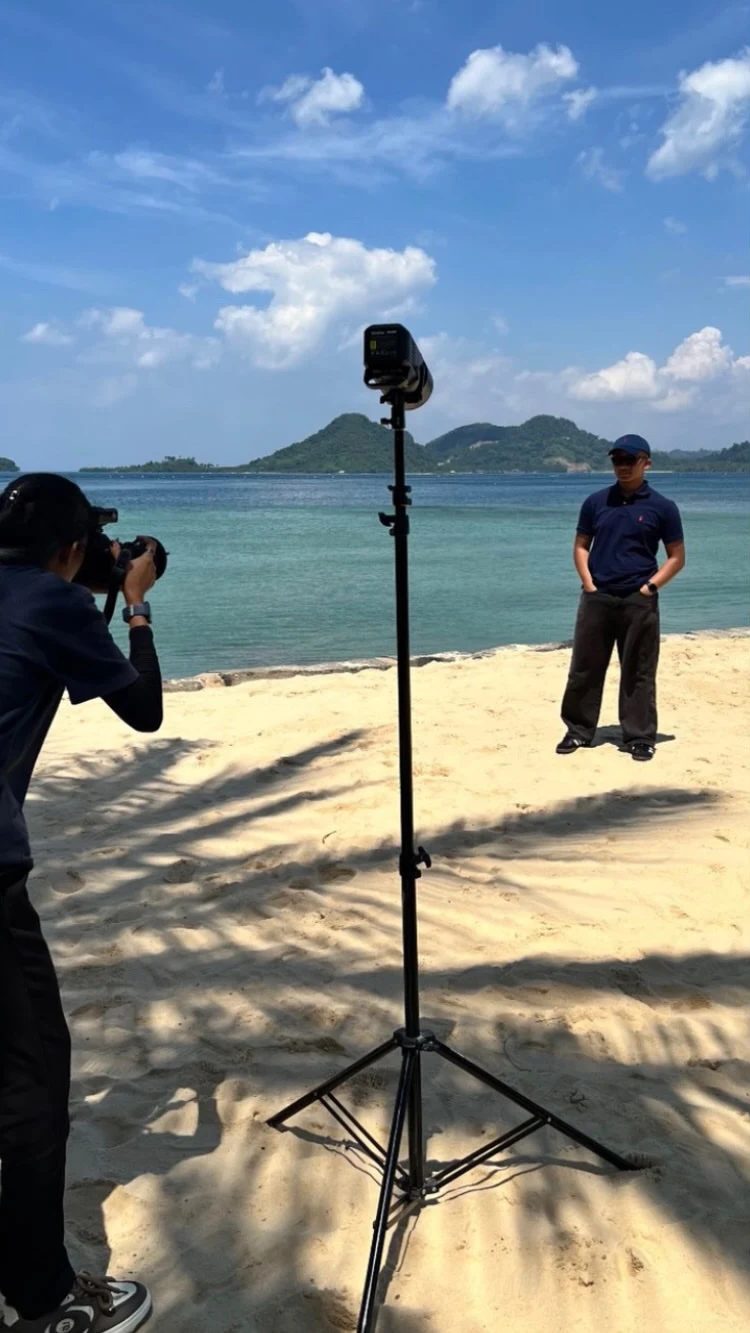 sora standing on a beach during a photo shoot